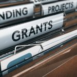 File folders labeled funding and grants
