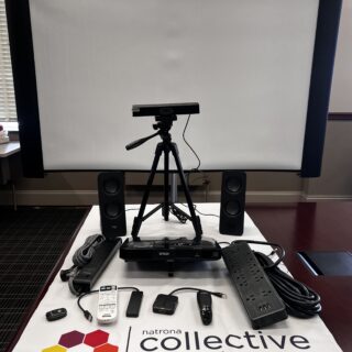 A table holding a variety of audio/visual tech equipment