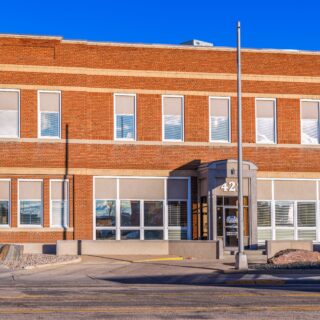 Photo of the front of a 2-story brick building