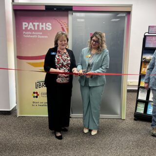 Ribbon cutting ceremony in front of new telehealth booth