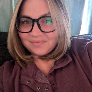 Woman with glasses posing for picture