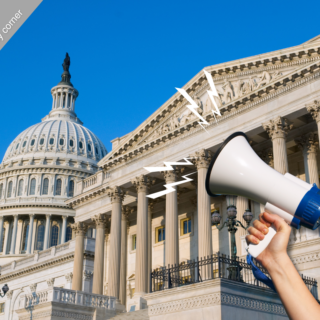 A hand holding a megaphone with US Capitol in the background