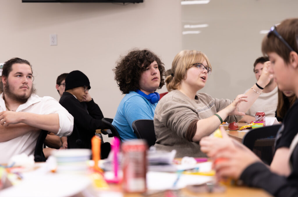 A group of youth gathered at tables for discussion