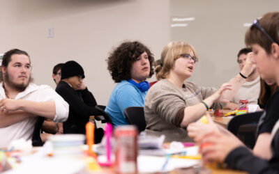 A group of youth gathered at tables for discussion