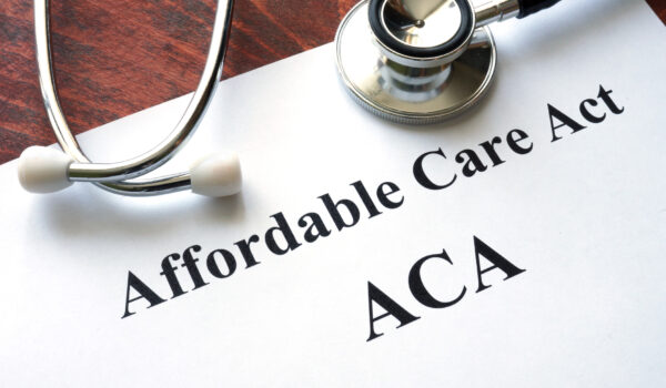 Words Affordable Care Act  ACA written on a paper.