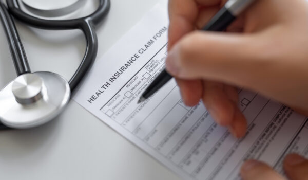 Woman filling Health Insurance claim form