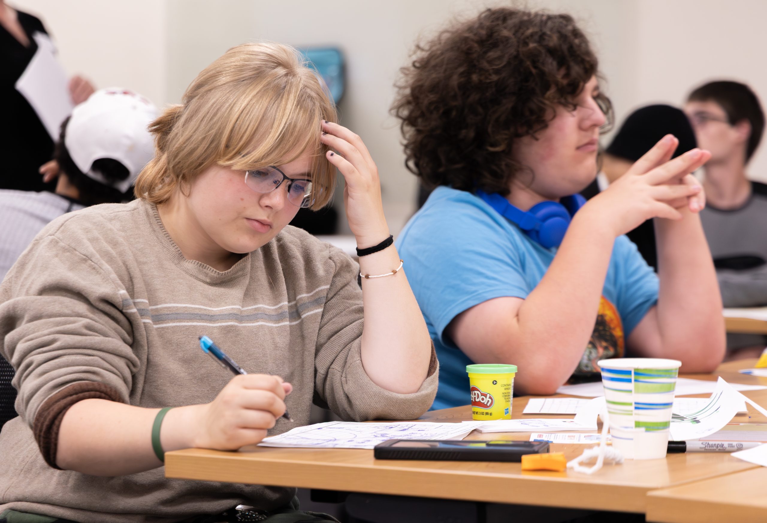 Teen writing ideas during a workshop session