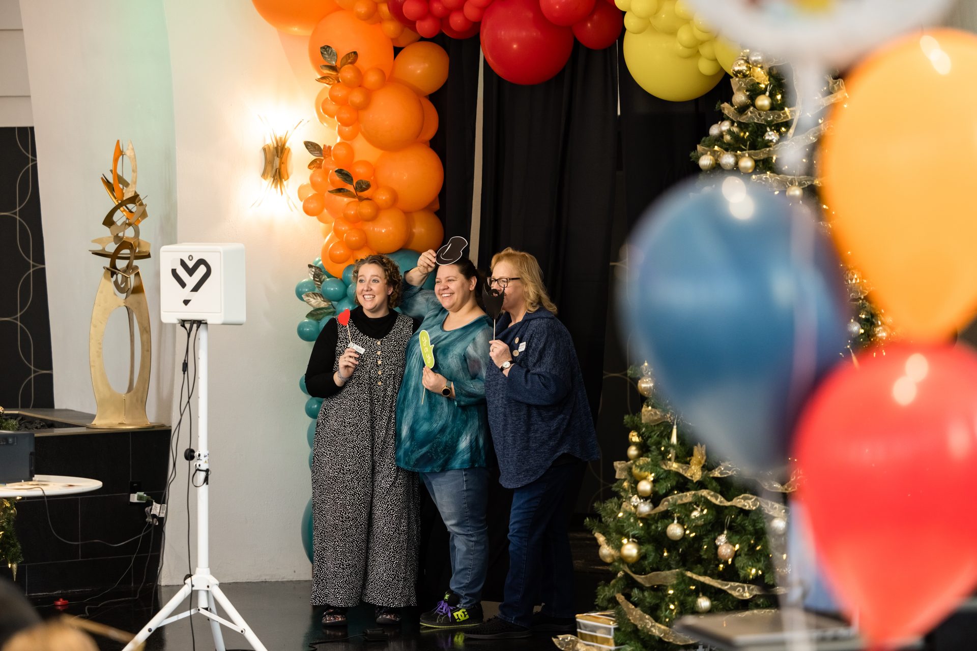 Three guests posing at the photo booth